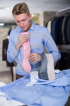 Adult male purchaser choosing tie