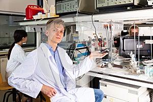 Adult male scientist sitting at biochemical lab