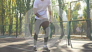 Adult male is training basketball skills outdoor