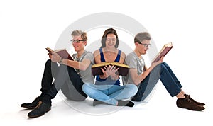 Adult male twins and young girl reading books