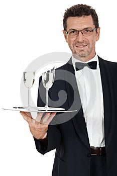 Adult male waiter serving two glass of champagne isolated