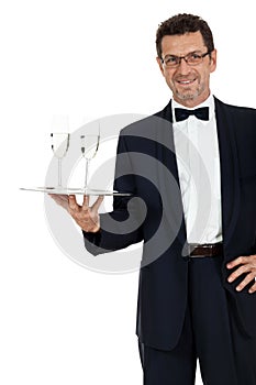 Adult male waiter serving two glass of champagne isolated