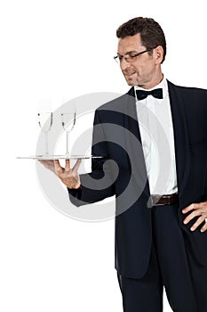 Adult male waiter serving two glass of champagne isolated