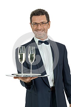 Adult male waiter serving two glass of champagne isolated