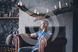 Adult man in blue t-shirt at home