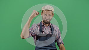 Adult man carpenter making fist sign