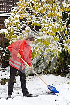 Adult man clean owns road to home against snow