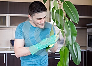 Adult man cleaning pipal in kitchen