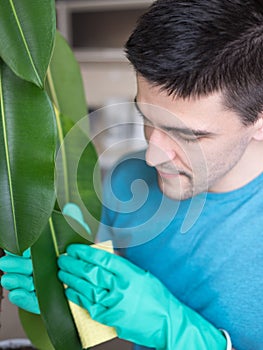 Adult man cleaning pipal in kitchen