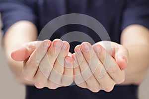 Adult man cupped hands showing something