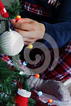 Adult man decorating Christmas tree at home.