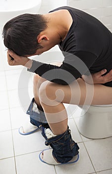 Adult man with diarrhea painful sitting toilet seat