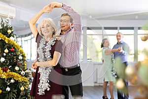 Adult man and elderly woman dance waltz