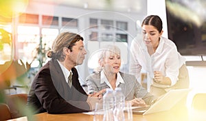 Adult man, elderly and young women having meeting in office