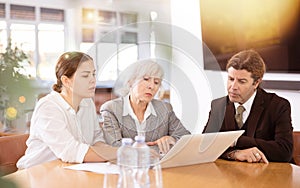 Adult man, elderly and young women having meeting in office