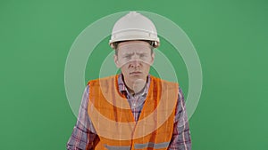 Adult man engineer looking suspicious at camera