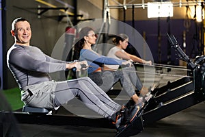 Adult man exercising on rowing machine