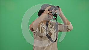 Adult man explorer chasing with binoculars