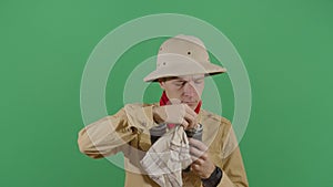 Adult Man Explorer Cleaning His Binoculars