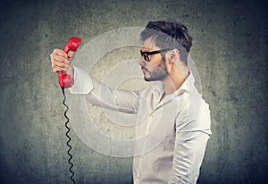 Adult man holding telephone handset