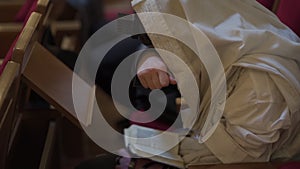 An adult man, a Jew, prays with his hand closed to his eyes.