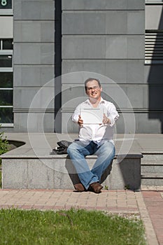 Adult man makes a picture with the tablet