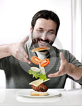 Adult man making a burger