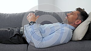 Adult man with mental health problems lying on couch listens psychologist