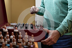 Adult man performing analysis with a radionic machine. Concept of alternative medicine