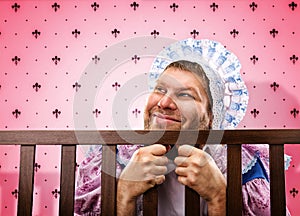 Adult man in playpen looking out photo