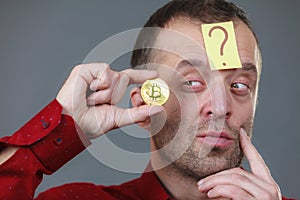 Adult man questioning bitcoin