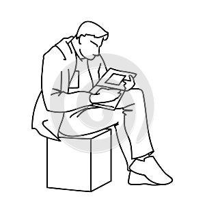 An adult man is reading a book sitting on a cube. Vector illustration of a man gazing intently into a magazine or