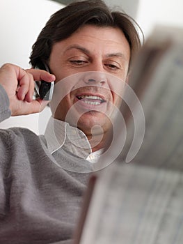 Adult man reading stock exchange listings at home