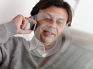 Adult man reading stock exchange listings at home