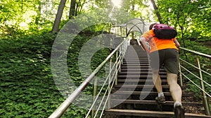 Adult man running jogging up the stairs outdoors in a forest nature on a forest trail