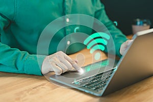 Adult man searching and connect for wifi on his a computer laptop in the cafe.