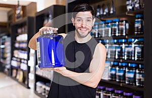 Adult man seller demostration sport products photo
