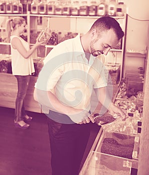 Adult man taking with scoop cereals sold