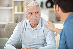 adult man talking to elderly guy