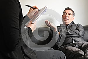 Adult man talking to a male therapist