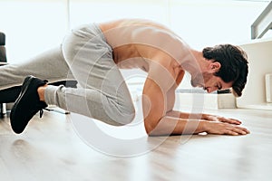 Adult Man Training ABS and Legs Doing Mountain Climbing Plank