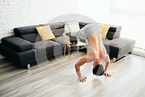 Adult Man Training Chest Muscles At Home Doing Inclined Push-Ups