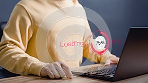 Adult man using a laptop computer for download software and waiting to loading digital technology data form website.