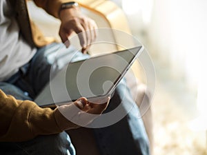 An adult man using modern digital tablet computer