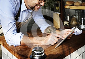 Adult Man Using Tablet in Bakery Shop photo