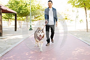 Adult man walking his cute dog with a leash
