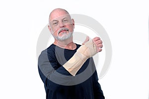 adult man wearing hand guard and wrist tendinitis injured arm looking forward business