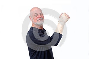 adult man wearing hand guard and wrist tendinitis injured arm looking forward business photo