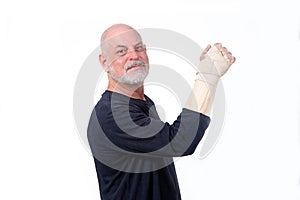 adult man wearing hand guard and wrist tendinitis injured arm looking forward business man and fashion expression  photo