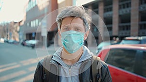 Adult man wearing protective coronavirus medical mask in down town